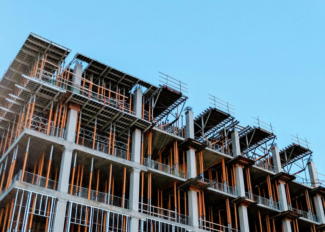 A partly-completed building against the blue sky