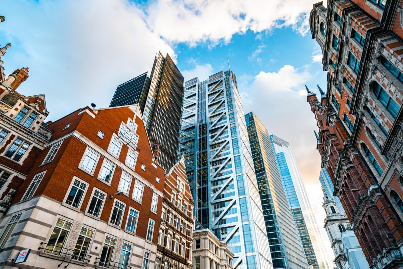 Picture of two brick buildings and a glass office in a city