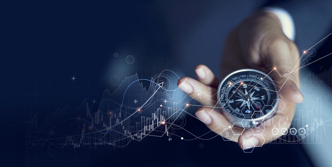 A hand holding a compass with graphics of charts and graphs overlaid