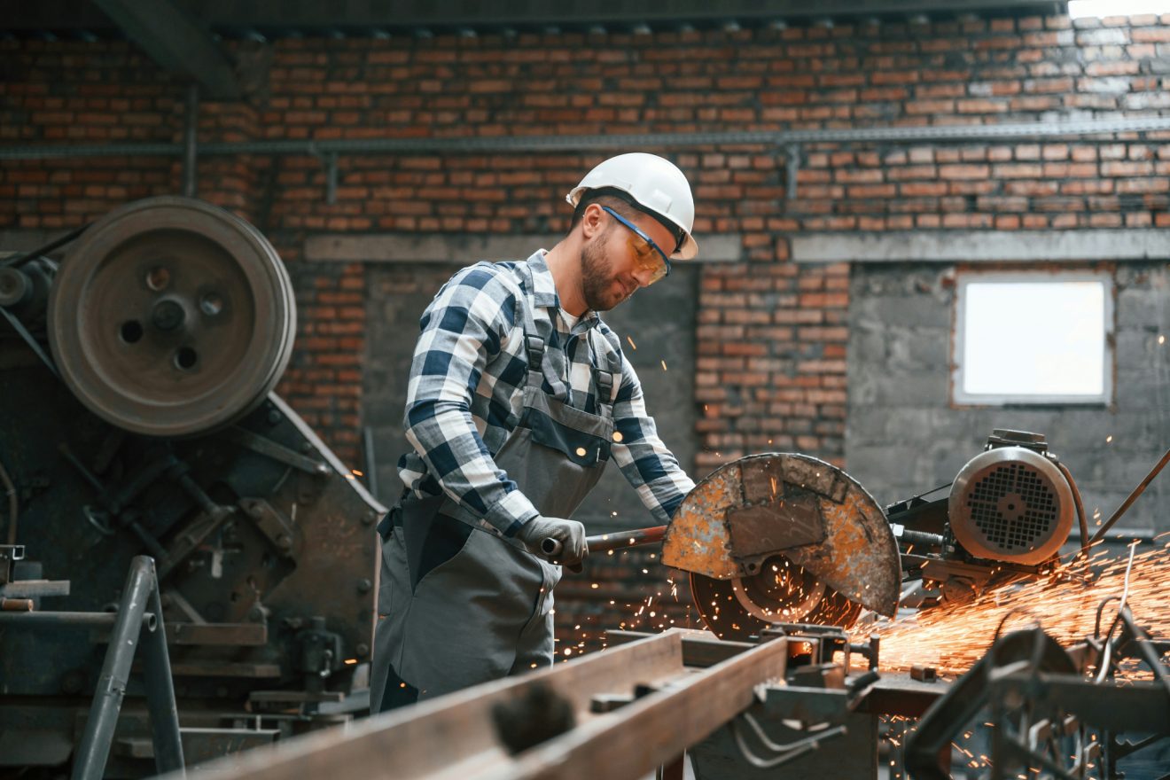 A man fixes a piece of equipment