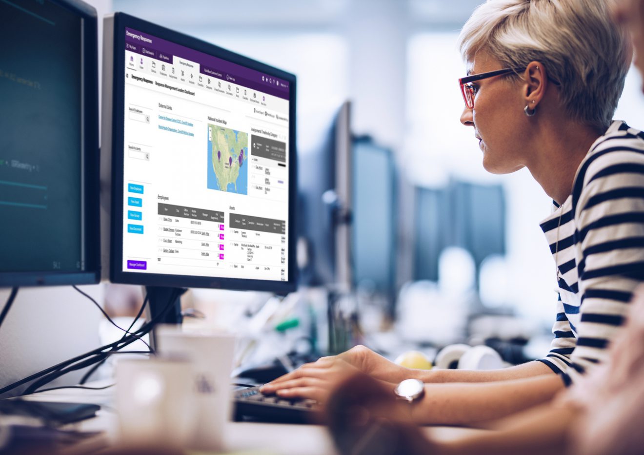 A woman uses a Quickbase app on her desktop computer.