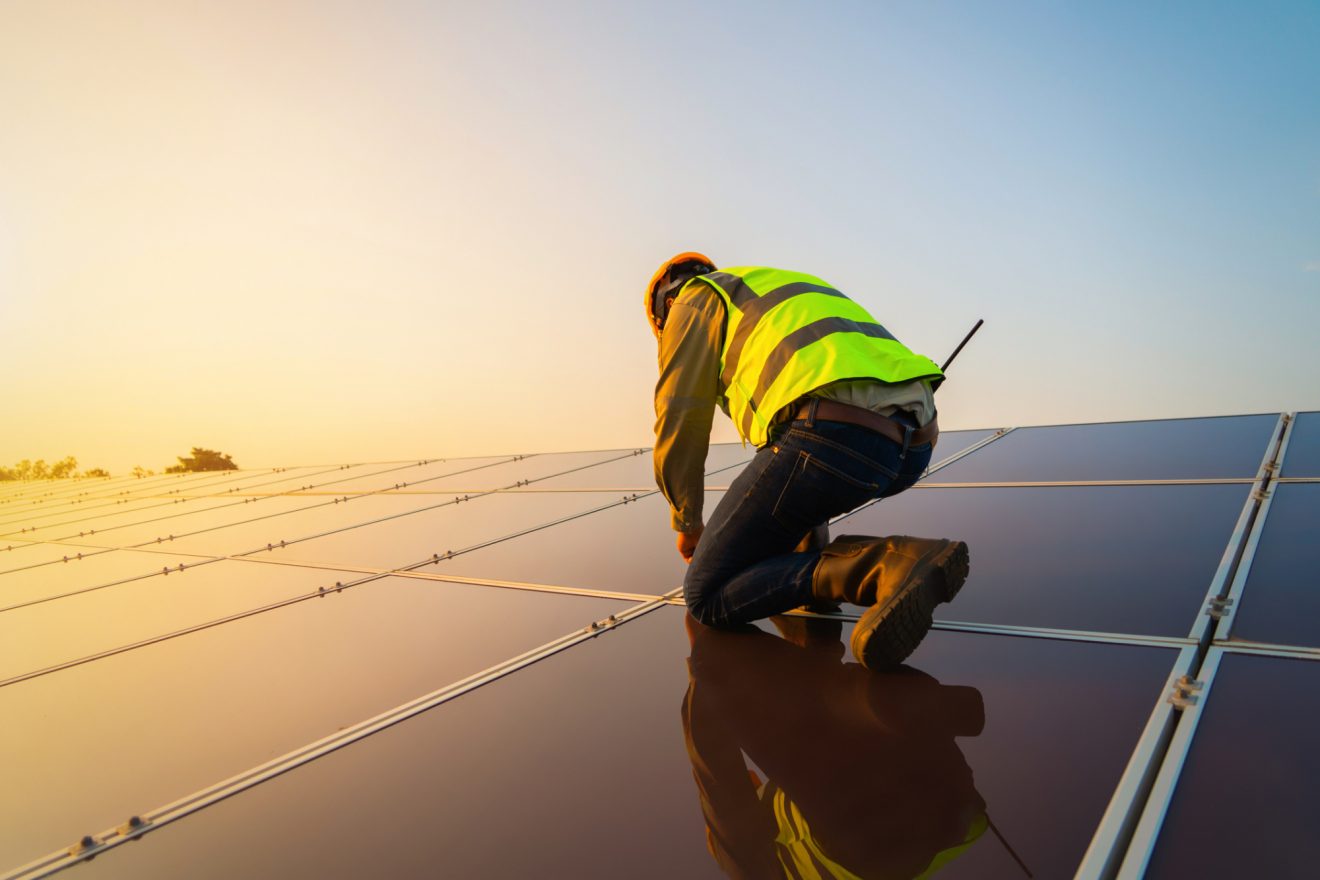 A person fixes a solar panel