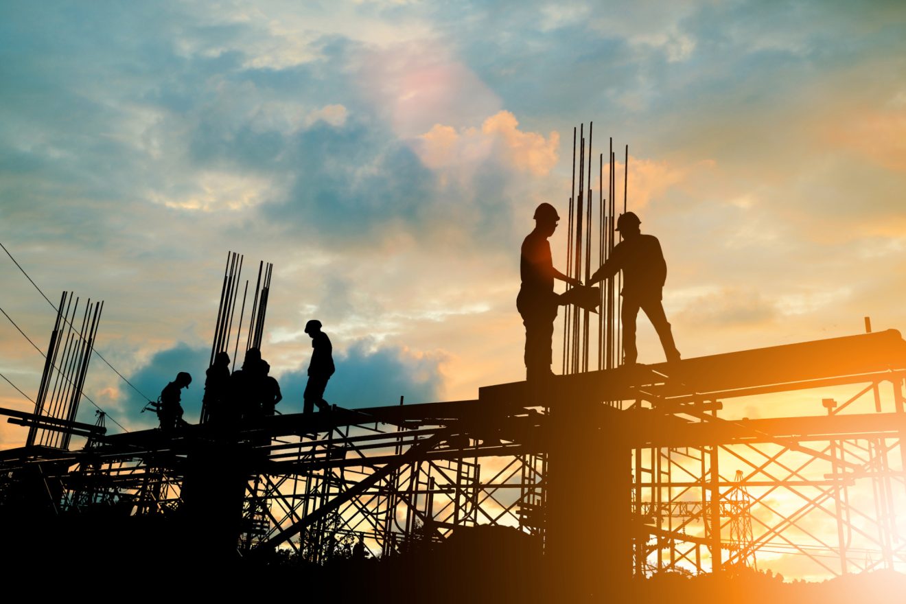 Silhouettes of workers on a construction site