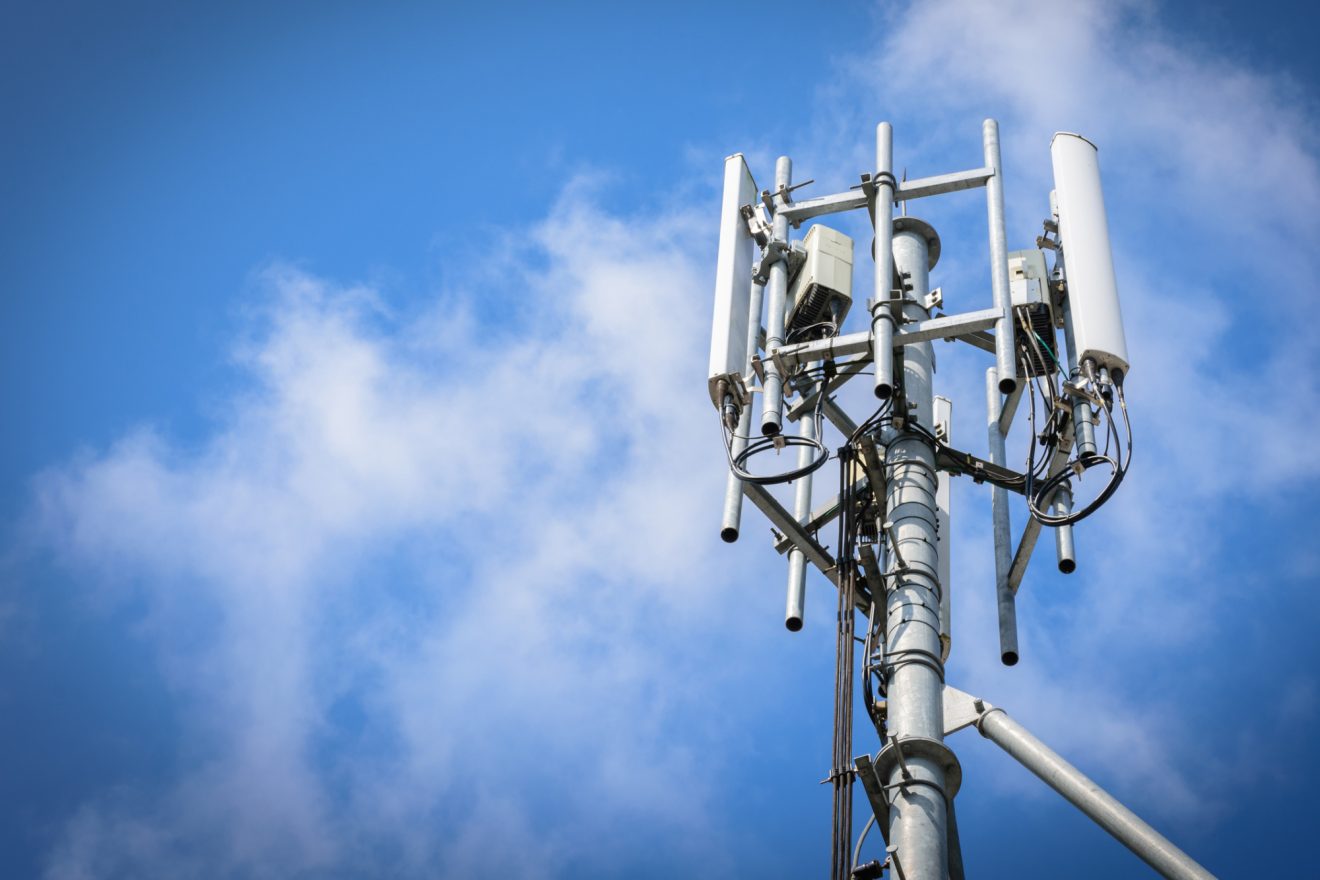 A telecommunications tower against a blue sky