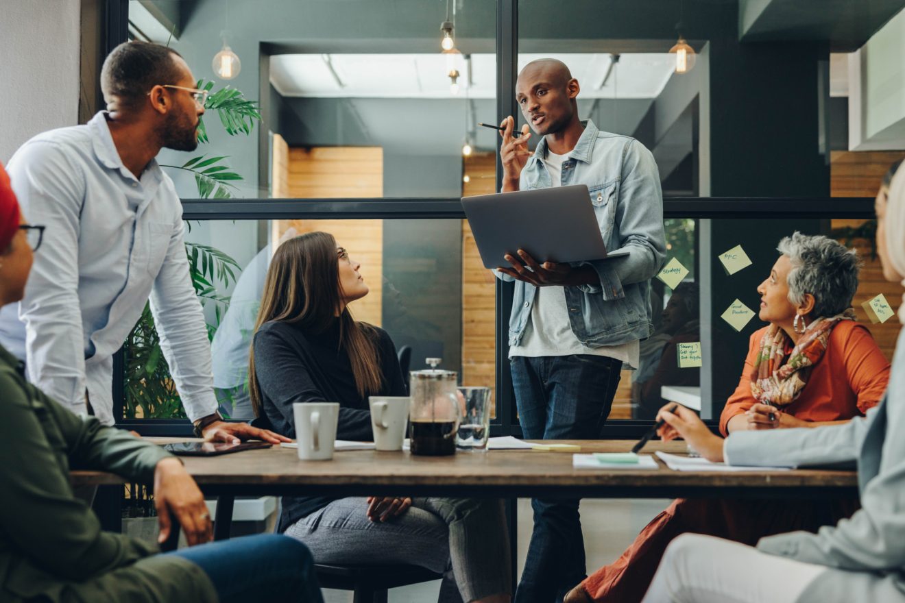 A group of people talk together during a casual meeting