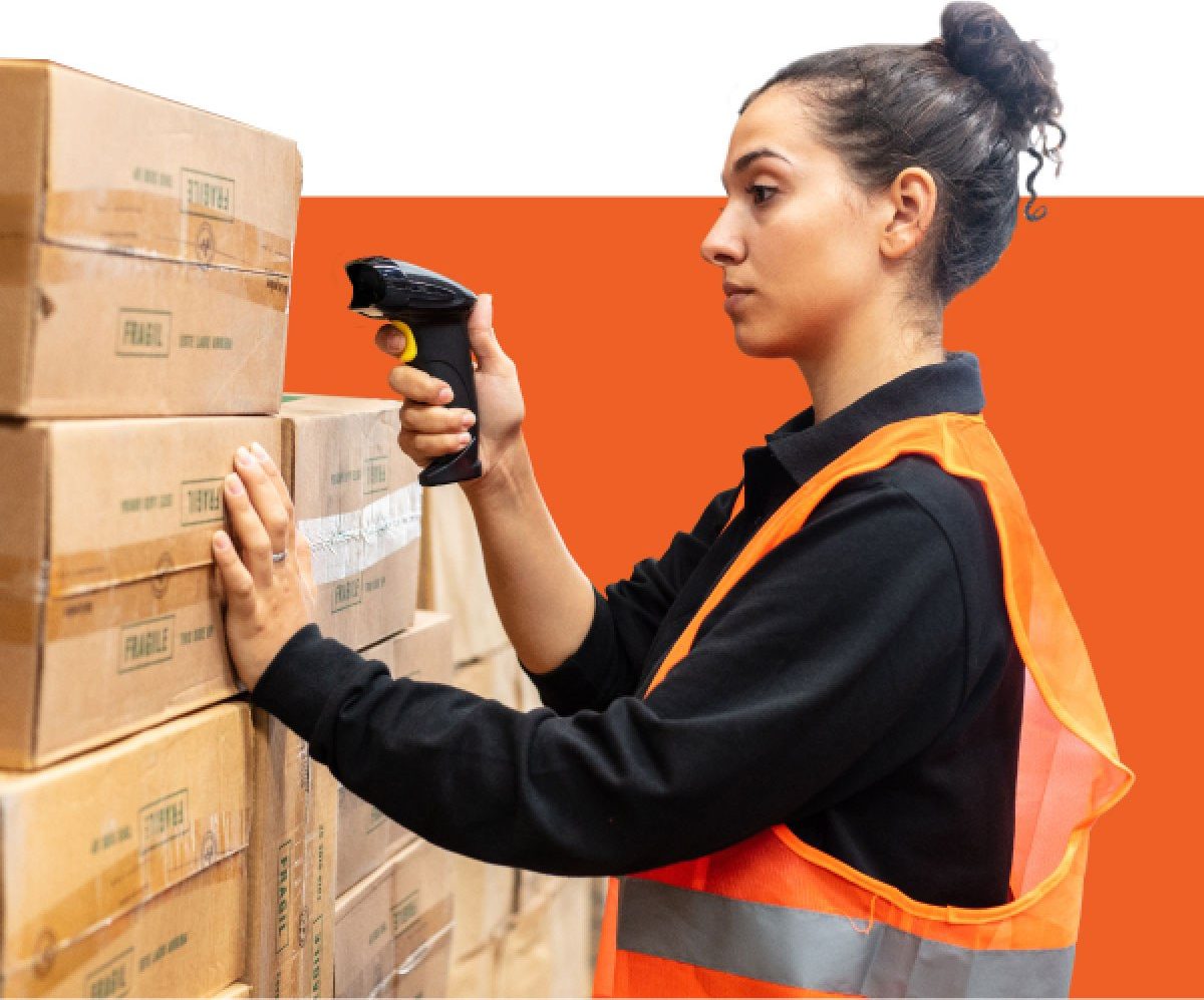 Woman scans boxes that are placed in stacks