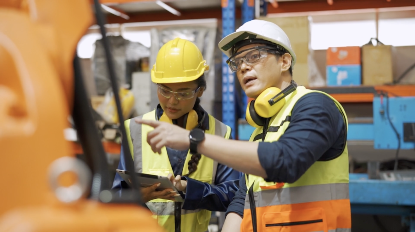 Man and woman in hard hats manufacturing
